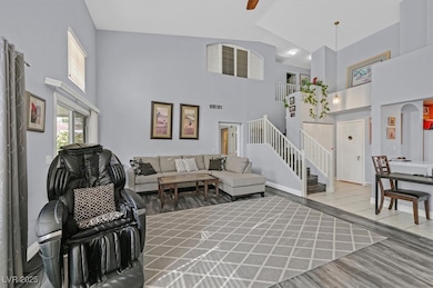 Living area with baseboards, wood finished floors,