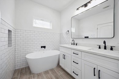 This gorgeous primary bathroom has a subway tiled