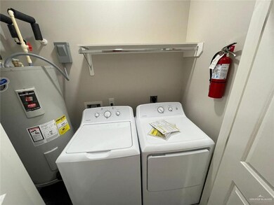 Laundry area featuring water heater and washer and dryer