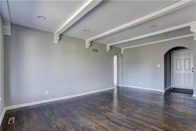 formal living room with white wooden beams across 