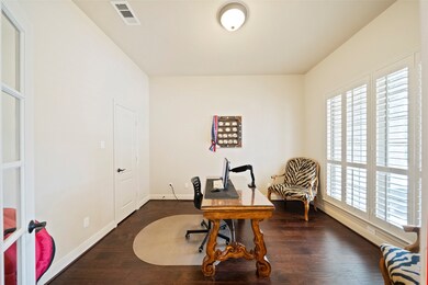 Dedicated home office with rich wood floors, large