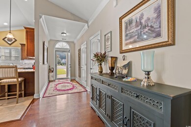 Entrance foyer with vaulted ceiling, dark hardwood