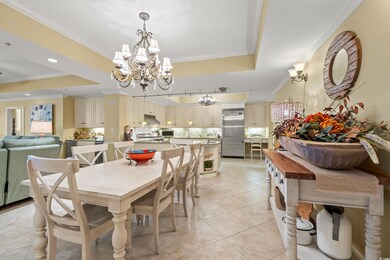 Dining room with ornamental molding, a chandelier,
