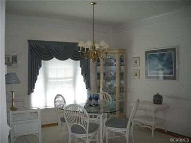 Breakfast area has hardwood floor, crown molding a
