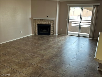 Unfurnished living room featuring a tile fireplace
