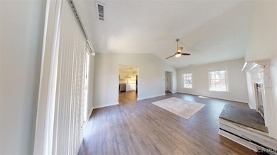 Unfurnished living room with ceiling fan, wood fin