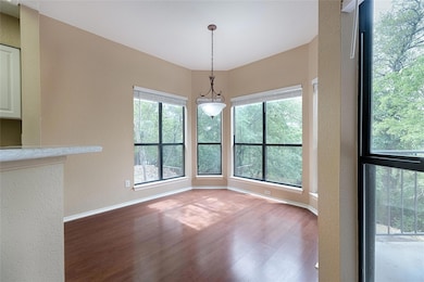 Unfurnished dining area featuring a textured wall and wood finished floors