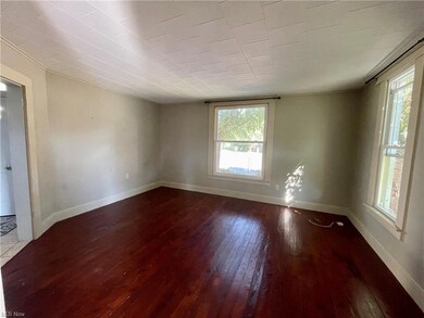 Living room with wood-type flooring, crown molding