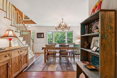 Dining Room with bay window view of gardens