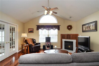 The living room offers gleaming hardwood floors, a