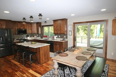 Open kitchen and dining with a new patio door out to the deck. (1).jpg
