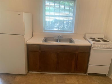 Kitchen featuring white appliances and light countertops