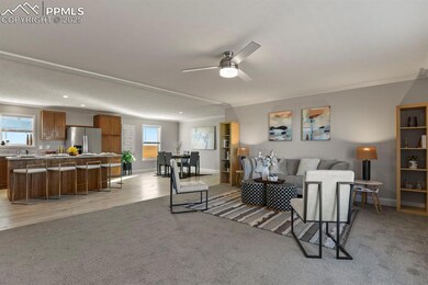 Living room with ornamental molding, ceiling fan, 