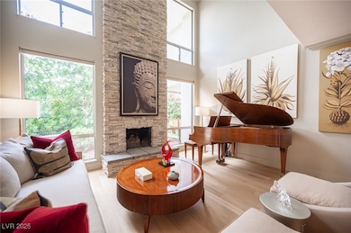 Living area featuring a fireplace, a towering ceil
