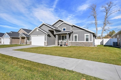 Craftsman-style home featuring stone siding, board and batten siding, concrete driveway, and an attached garage