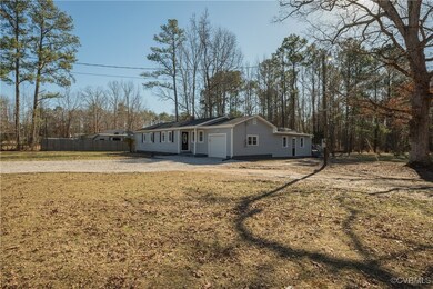 View of front of property featuring fence, drivewa