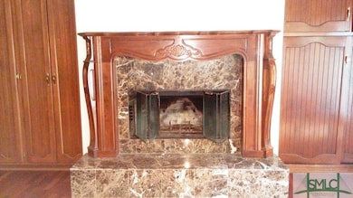 Marble fireplace with wood trim in family room fla