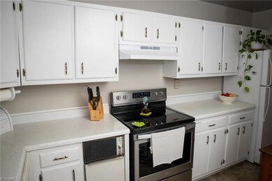 Closer View Of Kitchen And Range With Refrigerator At Right