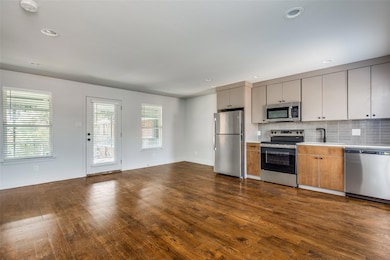 Kitchen featuring stainless steel appliances, tast