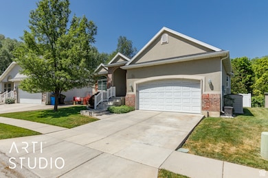 Ranch-style house featuring a front lawn, brick siding, a garage, driveway, and stucco siding