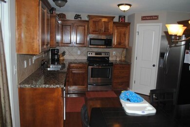 Granite Counters, Pantry & Hardwood Floors in Kitc