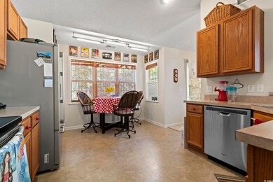 Kitchen featuring a textured ceiling and appliance