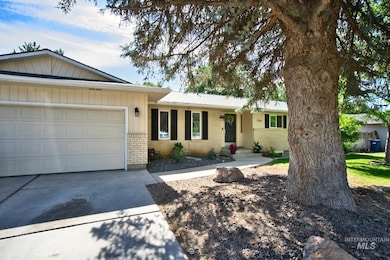 Ranch-style house with brick siding, a garage, and driveway