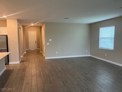 Empty room featuring dark hardwood / wood-style fl