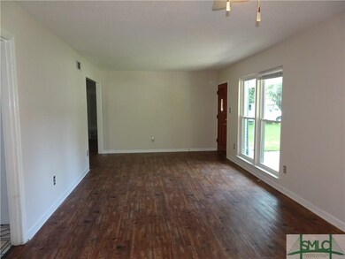 Large living room with vinyl plank flooring and do