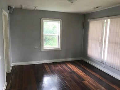 Spacious living room with laminate flooring and window blinds