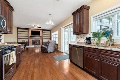 Updated cabinets and granite counter top. Stainless steel appliances. Family room with built in shelves and mounted T.V. Lovely real wood flooring. Go through the sliding glass door and you will be in your sun room.