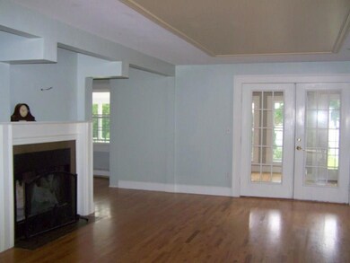 Living room with wood burning fireplace.