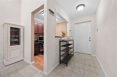 Entrance foyer with light tile patterned flooring,