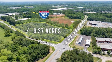 Aerial overview of property's location featuring a forest and property boundaries highlighted