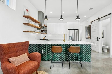 Kitchen featuring white cabinets, appliances with