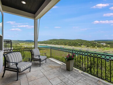 View of patio with a water view and a balcony
