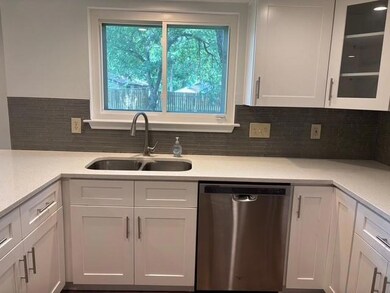 Kitchen featuring stainless steel dishwasher, whi