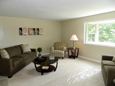 Living Room. New carpet, baseboard, and painted