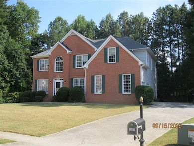 View of front of house featuring brick siding and a front lawn