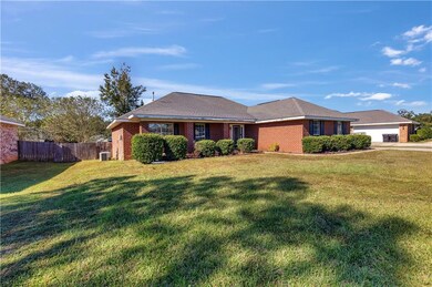 Ranch-style house with a front yard, a garage, and