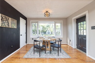 Dining space with a textured ceiling, baseboards,