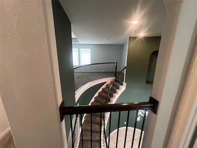 Staircase with baseboards and a textured wall