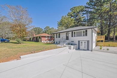 View of front facade with a patio area and view of wooded area