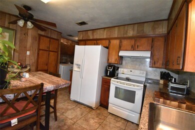 Kitchen featuring washer and dryer, white applianc