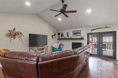 Living room featuring lofted ceiling, dark wood-ty