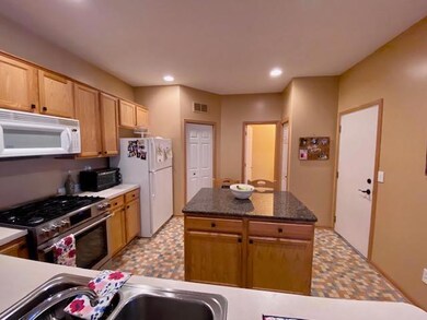 Breakfast bar overlooks kitchen with center island
