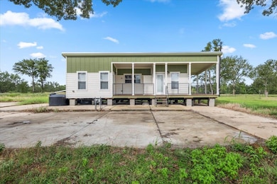 View of front of home with a porch and concrete d