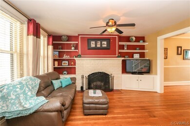 Built-in shelving surrounds brick fireplace