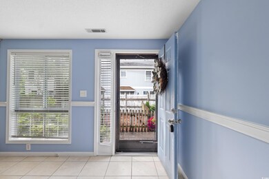 Doorway to outside featuring healthy amount of natural light, tile patterned floors, and baseboards