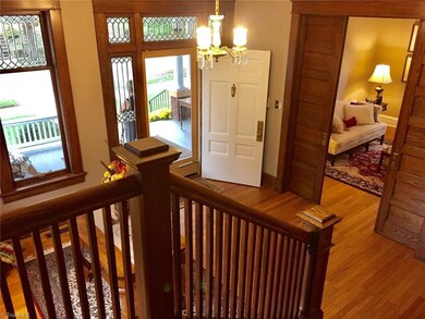 Foyer viewed from staircase. Living Room visible at right between pocket doors.